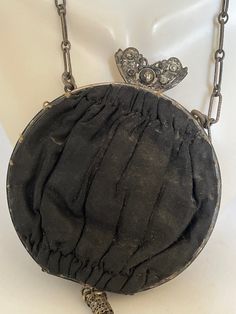 "Lovely Victorian Dainty silk purse with a delicate chain strap known as \"Opera Bags''. These small bags accompanied women on special outings. This bag has a decorative clasp and tassel. Inside are two compartments, one holding a small round mirror on a chain. Body of bag is 3.5\" across. Chain is 8\" long. Tassel is 3\" long. No holes or tears in exterior. Interior fabric is faded and a bit worn looking." Elegant Clutch Coin Purse For Travel, Elegant Compact Shoulder Bag For Evening, Elegant Formal Coin Purse With Dust Bag, Elegant Compact Travel Bag, Elegant Coin Purse For Travel, Compact Evening Bag With Removable Pouch, Elegant Black Coin Purse For Evening, Chic Compact Evening Coin Purse, Chic Compact Coin Purse For Evenings