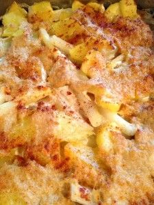 a casserole dish with cheese and potatoes