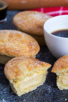 several pastries on a table next to a cup of coffee