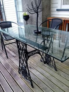 a glass table sitting on top of a wooden deck