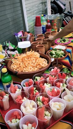 there are many cups with food in them on the table