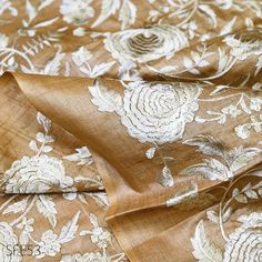 the fabric has been made with gold and white flowers