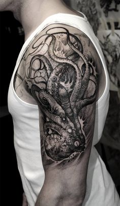 a man's arm with an octopus tattoo on it