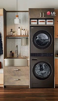 a washer and dryer in a room with wood flooring, cabinets and shelves