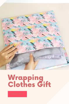 a person wrapping clothes on top of a table with the words wrapping clothes gift underneath it