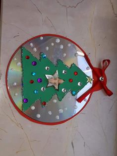 a metal plate with a christmas tree cut out on it and a pair of red scissors next to it