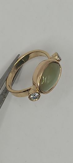 We handmade this ring in the 1990's. It features a beautifull rare cat's eye chrysoberyl 13 millimeters by 10 millimeters,  and 2 diamonds approximately .40 carat. The gold is 18kt. The ring weighs approximately 7 grams. The finger size is approximately size 6. The band is approximately 3.5 millimeters wide. The style of this ring is definitely 60's mid century. The chrysoberyl is a rare sought after stone. Rare Cats, Cats Eye, Vintage Cat, Bling Bling, Rings Statement, Gold Ring, Cat Eye, Statement Rings, Gold Rings