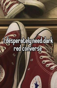 someone is wearing red converse shoes and the caption reads i desperately need dark red converse