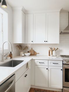 the kitchen is clean and ready for us to use it's white cabinets, stainless steel appliances, and wood floors