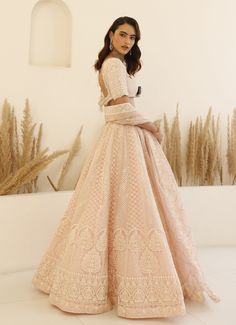 Step into timeless elegance with an enchanting Blush Pink Chikankari Lehenga Set, meticulously crafted from luxurious organza. The blush pink lehenga features exquisite chikankari work and shimmering sequins that catch the light with every movement, creating a mesmerizing visual effect. The matching half sleeve classic blouse is equally captivating, adorned with intricate chikankari and sequin detailing that perfectly complements the lehenga. Completing the look is a beautifully draped dupatta, enhancing the overall charm and grace of the outfit. Perfect for special occasions like Sangeet, Mehendi, or as a wedding guest outfit. Composition : Lehenga, Blouse & Dupatta : Organza Care: Dry Clean Only and Vacuum Storage This product can be customized for sleeves, length and colour Delivery : 4 Pink Chikankari Lehenga, Blush Pink Lehenga, Studio Iris, Chikankari Lehenga, Chikankari Work, Classic Blouse, Vacuum Storage, Pink Lehenga, Classic Blouses