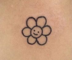 a smiley face drawn on the back of a woman's stomach