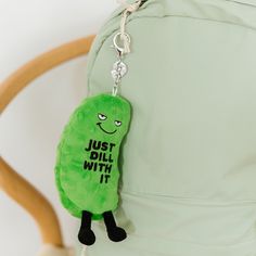 a green pickle keychain that says just dill with it on it