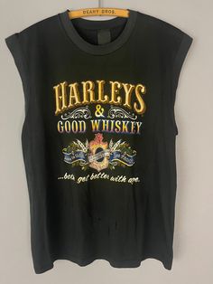 "Vintage Harley Davidson motorcycle tank top/T-shirt, Harley's and Whiskey rare graphic New York, muscle tee, soft worn in 80s biker shirt TAG SIZE: n/a MATERIAL: n/a MEASUREMENTS LAYING FLAT in INCHES: SHOULDER TO SHOULDER: 18 1/2\" ARMPIT TO ARMPIT: 20 1/2\" LENGTH TO WAISTLINE: 25\" # 402 ALL T-SHIRTS IN MY SHOP ARE TRUE GENUINE VINTAGE, NOT REPRINTS! I AM HAPPY TO COMBINE SHIPPING ON MULTIPLE ITEMS, IF YOU HAVE ANY QUESTIONS OR REQUESTS PLEASE FEEL FREE TO REACH OUT AND I WILL ACCOMMODATE YO Tank T-shirt With Letter Print For Streetwear, Grunge Crew Neck Tank Top With Letter Print, Retro Graphic Print Tank Top, Retro Crew Neck Tank Top With Graphic Print, Crew Neck Graphic Print Tank Top, Sleeveless Grunge T-shirt With Letter Print, Graphic Print Crew Neck Tank Top, Vintage Tank T-shirt For Summer, Vintage Sleeveless T-shirt With Graphic Print