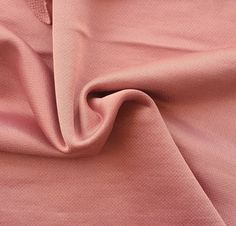 a pink fabric textured up close to the camera