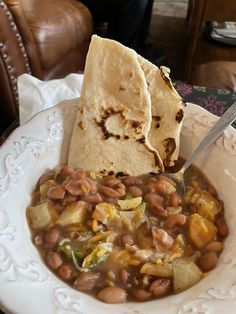 a white plate topped with beans and tortilla