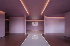 an empty room with purple walls and flooring is lit by dim lighting from the ceiling