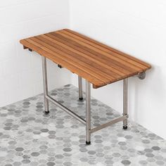 a wooden table sitting on top of a tiled floor