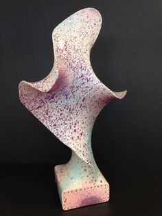 a white and purple sculpture sitting on top of a table