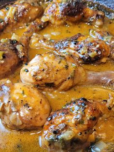 some chicken is cooking in a yellow sauce