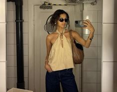 a woman taking a selfie in the bathroom