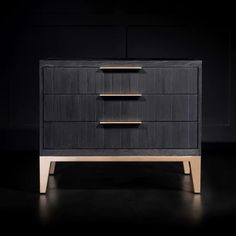 a black and gold dresser with three drawers