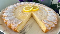 a lemon cake on a plate with one slice cut out