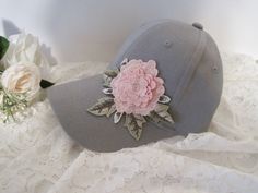 "I designed this adorable grey Youth Toddler baseball cap with a beautiful embroidered Pink Flower. This hat is so cute. These hats are really nice quality. Inside dimensions is approximately 20\" the velcro strap will add 3\" larger or smaller. velcro pony tail back These hats are washed cotton twill. see more youth toddler cadet and baseball hats here: https://www.etsy.com/shop/theraggedyrose?ref=seller-platform-mcnav&section_id=21134612 CUSTOM ORDERS ALWAYS WELCOME.... Will ship in 1 to 2 Gray Spring Visor Hat, Gray Baseball Cap For Spring, Gray Cap For Spring, Gray Spring Cap, Gray Snapback Hat For Spring, Adjustable Brimmed Gray Baseball Cap, Gray Curved Brim Baseball Cap For Spring, Gray Brimmed Baseball Cap, One Size Fits Most, Girl Hats