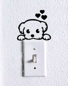 a white light switch with a dog on it's face and hearts above the head