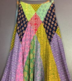 "This vintage 1970s hippie skirt is the real thing. Different diamond shaped patches along with strips of printed fabric fit together to make the most beautiful skirt. It fits snug at the waist with a side zipper and hook and eye enclosure and then flares out dramatically as the skirt lengthens. The tag in the back says, Made in India for India Imports of Rhode Island, Inc.  100% Cotton, Cold Wash Separately, No Bleach, Steam Iron. XS.  This fabulous vintage 1970s hippie skirt measures: Waist is Patchwork Skirt Diy, Patchwork Skirt Pattern, Fashion Upcycling, Quilted Bag Patterns, Hippie Skirt, 1970s Hippie, Patchwork Fashion, Upcycle Clothes Diy, Hippie Skirts