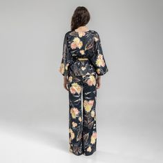 Experience effortless style and comfort with our Balance Kimono Top. This viscose blend kimono features an asymmetrical design and a v-neckline. The beautiful floral print adds a touch of femininity to the pinstriped fabric. This kimono top features an inset adjustable belt at backwaist to quickly alter it to your silhouette. Dress it up with heels or dress it down with trainers for a versatile look. 40% CO 40% VI 15% PE 5% EA  Fine wash at 30 degrees Iron at middle heat Do not tumble dry Spring Printed Viscose Sets, Bohemian V-neck Sets For Spring, Summer Floral Print Rayon Set, Chic Rayon Sets For Spring, Floral Print V-neck Kimono For Brunch, V-neck Floral Print Kimono For Brunch, Chic V-neck Summer Kimono, Elegant V-neck Kimono For Spring, Elegant V-neck Printed Sets