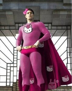 a man dressed as hello kitty standing in front of a window with a pink cape