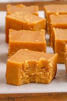 several pieces of peanut butter fudge sitting on top of a piece of parchment paper