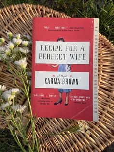 the book recipe for a perfect wife by karma brown sits on a wicker basket