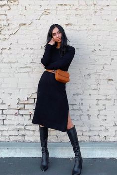 Woman in black knit dress with tall black boots