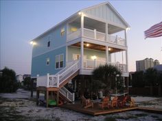 a beach house is lit up at night