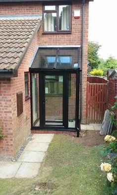 a brick house with a black glass door