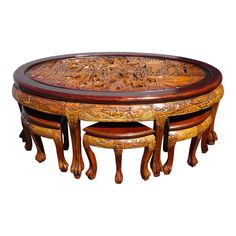 an ornately carved table with stools on it's sides and two tables in the middle