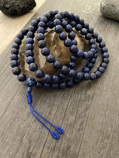 This Lapis Lazuli Mala necklace has a beautiful blue tone that will be easy to match your everyday outfits and keep you calm and grounded if you use it while meditating. Its a unique decor item also. A perfect gift for a yoga lover, or someone that loves stones. You can use it as a necklace or wrap it around the wrist and becomes a bracelet. The Mala necklace has a drop length of 43cm- 17 inch. A most have addition to your jewelry collection. ⚡️Join Akashi's VIP list for early bird discount acce Spiritual Hand Wrapped Necklaces With Round Beads, Spiritual Round Beaded Bracelets For Meditation, Spiritual Beaded Bracelets For Meditation, Meditation Beaded Bracelets With Polished Beads, Polished Beads Bracelet For Meditation, Adjustable Spiritual Beaded Necklaces For Gifts, Spiritual Hand Wrapped Round Beads Jewelry, Round Polished Beaded Bracelets For Meditation, Hand Wrapped Round Spiritual Necklace