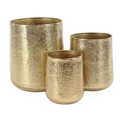 three gold vases sitting next to each other