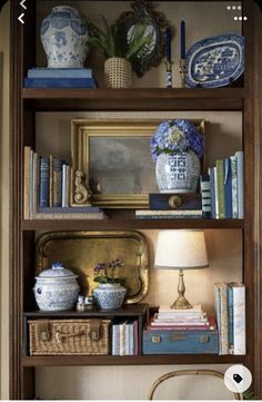 a book shelf filled with books and vases