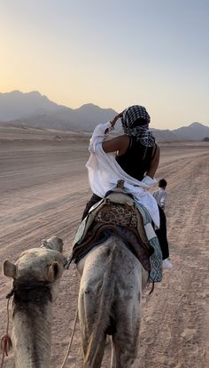 a man riding on the back of a camel