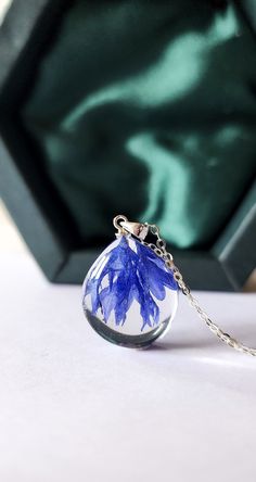 a glass ball with blue flowers in it sitting on a table