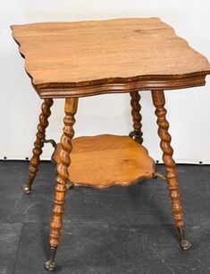 an old wooden table sitting on top of a black floor