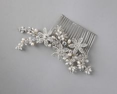 ring a bright detailed style to your wedding day hair style with this beautiful wedding hair comb. It is completely covered in crystal stones and accented with ivory freshwater pearls for an elegant look.

silver plate components
crystal stones
ivory freshwater cultured pearls
on an alligator-style pinch clip
5 inches long and 2 inches wide Pearl Bridal Comb, Wedding Day Hair, Beautiful Wedding Hair, Gold Headpiece, Wedding Hair Comb, Bridal Comb, Vintage Inspired Jewelry, Pearl Bridal, Head Hair