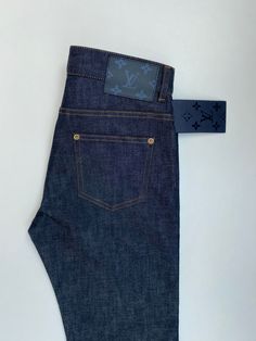 These dark blue Louis Vuitton jeans feature a Monogram Cobalt patch on the back and a small circled LV initials logo on the front pocket. Made in: Japan Material: Cotton Size: 26 LV / 26 US Approximate Measurements: Waist: 37 cmLeg Opening: 17 cmLength: 110.5 cmRise: 26 cmInseam: 86.5 cm Condition: NEW with tags. Lv Jeans, Louis Vuitton Jeans, Blue Louis Vuitton, Initials Logo, Louis Vuitton Men Shoes, Louis Vuitton Men, Slim Jeans, Types Of Shoes, Made In Japan