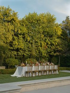 an outdoor table set up for a formal dinner