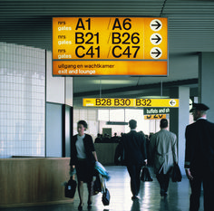 people walking through an airport with luggage and signs above them that read, at b2l / b9e / c4 / c7