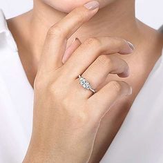 a woman wearing a diamond ring on her finger