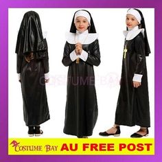 two girls in nun costumes are standing side by side and one is holding a cross