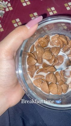 a person holding a glass bowl filled with cereal